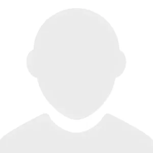 A simple, gray silhouette of a person’s head and shoulders on a white background, commonly used as a placeholder profile image.